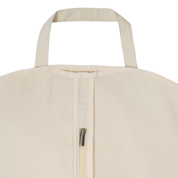 Close-up of a beige cotton garment bag with a zipper and handle on a white background