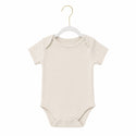 Beige baby onesie on a white background