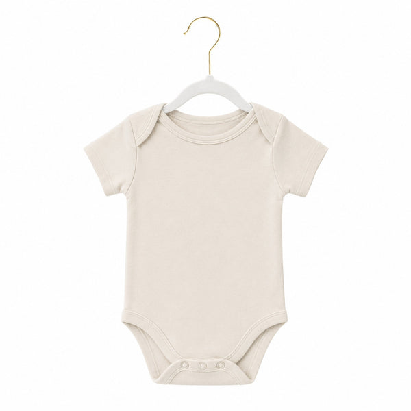 Beige baby onesie on a white background