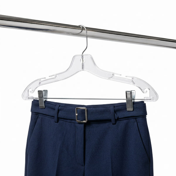 Navy blue pants with a belt on a clear hanger against a white background