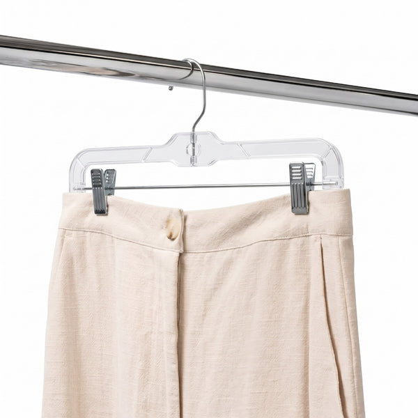 a beige colour trouser is hanging on a clear pant hanger with clips 