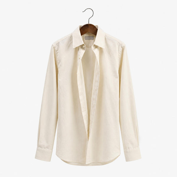 Beige dress shirt on a hanger against a white background