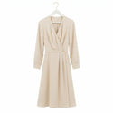 Cream colour women dress hang on a white wood suit hanger with gold hook