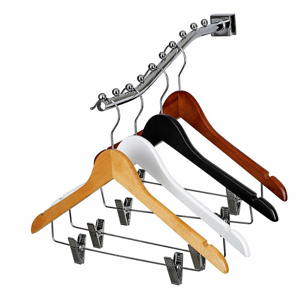 Set of wooden and metal hangers with clips on a white background