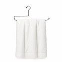 Metal hanger holding a folded white duvet cover on a plain background
