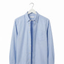 Light blue button-up shirt on a white hanger against a white background