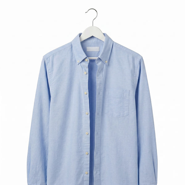 Light blue button-up shirt on a white hanger against a white background