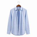 Light blue striped shirt on a hanger against a white background