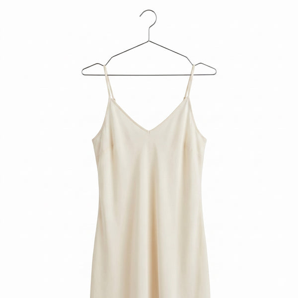 A beige colour dress hang on a chrome metal hanger