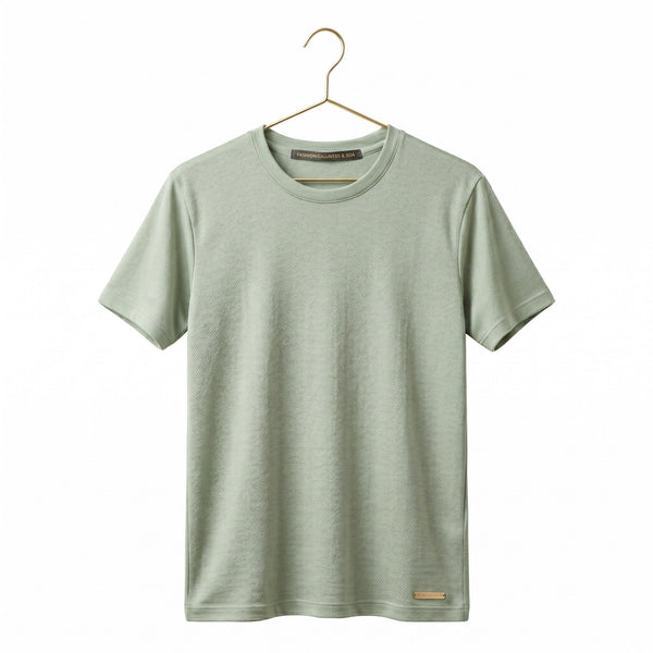 green short-sleeve shirt on a gold colour metal hanger against a white background