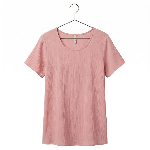 Pink t-shirt on a hanger against a white background