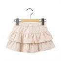 Three-layered skirt with a subtle pattern on a hanger against a white background