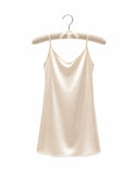 Beige satin slip dress on a hanger against a white background