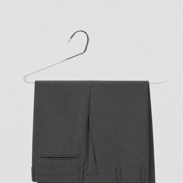 Gray pants on a hanger against a light gray background