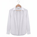 White shirt on a wooden hanger against a white background